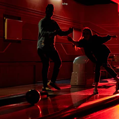 Couple bowling in a club atmosphere