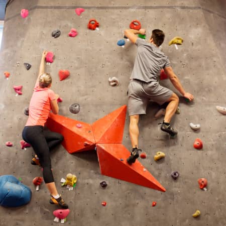 Couple indoor rock climbing