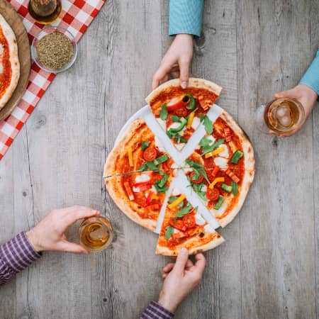 Couple sharing pizza and beer