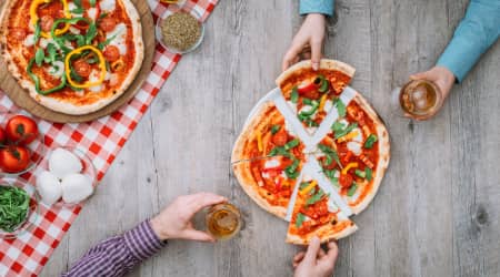 Couple sharing pizza and beer