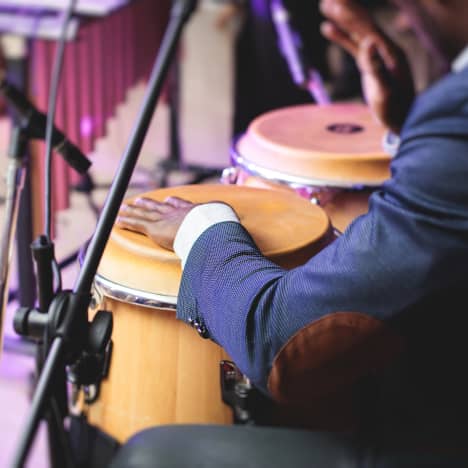 Performer on bongo drums