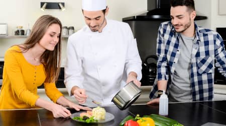 Private Chef Giving Cooking Lessons to Couple