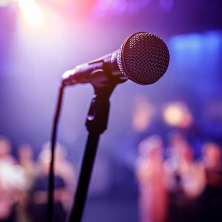 Microphone at a Comedy Club with Audience