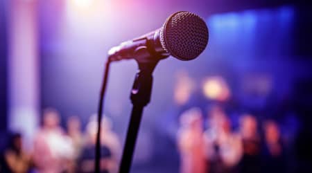 Microphone at a Comedy Club with Audience